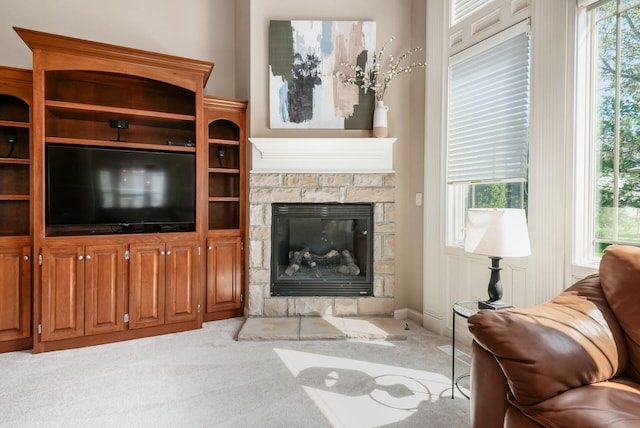 4568 Hickory Rock Dr, Powell, OH 43065 - living room with carpet flooring, a stone fireplace, and plenty of natural light