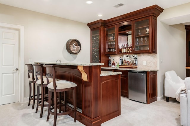 4568 Hickory Rock Dr, Powell, OH 43065 - bar featuring tasteful backsplash, visible vents, light colored carpet, indoor wet bar, and refrigerator