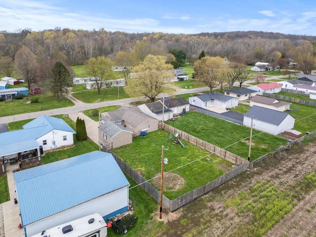 birds eye view of property with a view of trees and a residential view