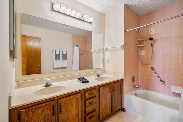 bathroom featuring double vanity, shower / bath combo with shower curtain, a sink, and a textured ceiling