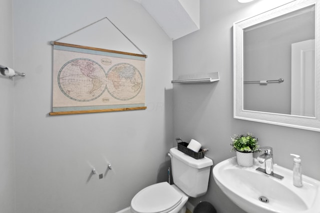half bath featuring a sink and toilet