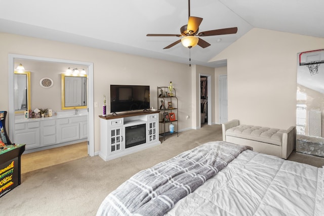 bedroom with carpet flooring, baseboards, lofted ceiling, and connected bathroom