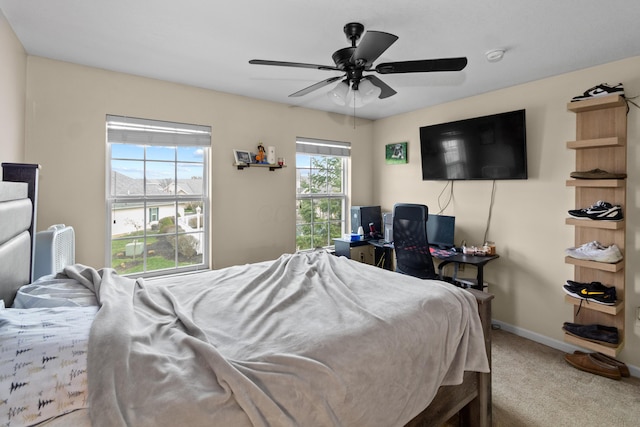 carpeted bedroom with baseboards and a ceiling fan