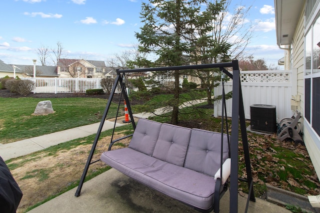 view of patio with central AC unit, a fenced backyard, and a playground