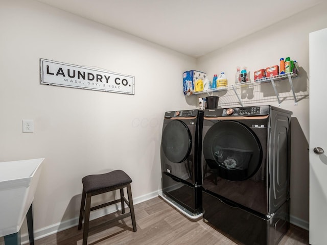 9239 Horseshoe St, Plain City, OH 43064 - clothes washing area with washing machine and dryer, baseboards, laundry area, and wood finished floors
