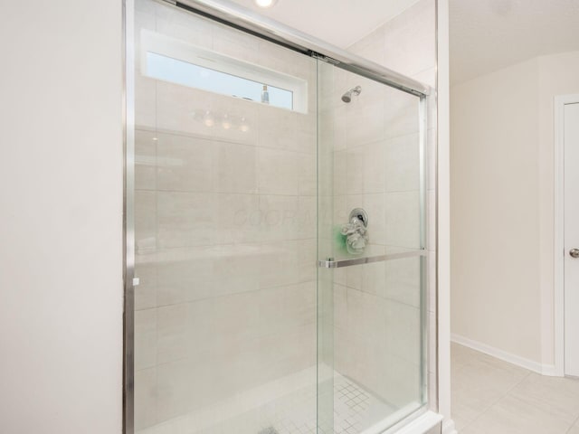 9239 Horseshoe St, Plain City, OH 43064 - bathroom with baseboards, a stall shower, and tile patterned flooring