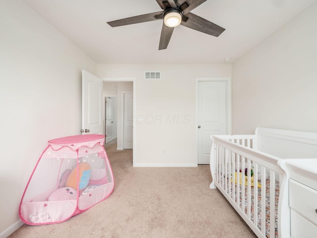 9239 Horseshoe St, Plain City, OH 43064 - carpeted bedroom with baseboards, visible vents, a crib, and a ceiling fan