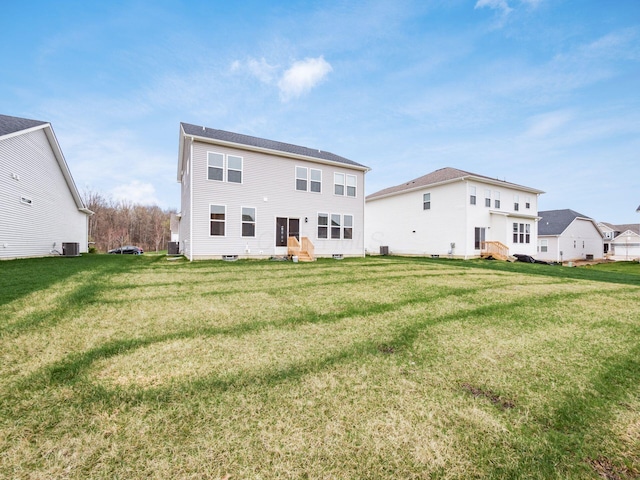 9239 Horseshoe St, Plain City, OH 43064 - back of property featuring a lawn, central air condition unit, and entry steps