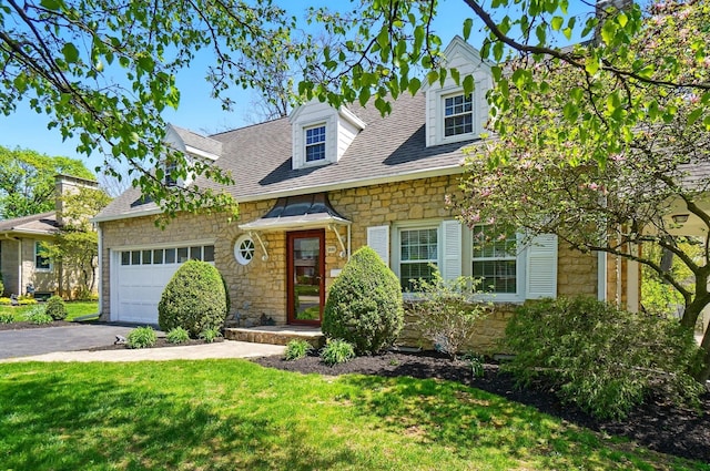 1800 Timberline Dr, Springfield, OH 45504 - cape cod house with an attached garage, a front lawn, aphalt driveway, and stone siding