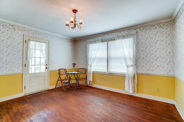 1800 Timberline Dr, Springfield, OH 45504 - dining space with crown molding, wallpapered walls, a chandelier, and wood finished floors