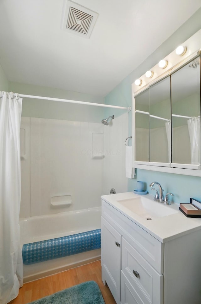1800 Timberline Dr, Springfield, OH 45504 - bathroom with visible vents, wood finished floors, shower / bath combo, and vanity
