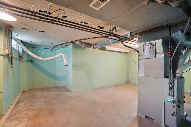 1800 Timberline Dr, Springfield, OH 45504 - unfinished basement featuring visible vents, heating unit, and concrete block wall