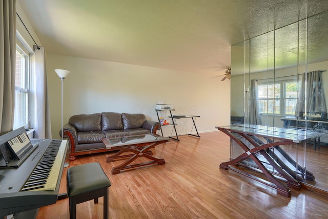 1473 Venice Dr, Columbus, OH 43207 - living area featuring baseboards, a ceiling fan, wood finished floors, and a healthy amount of sunlight
