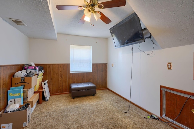1473 Venice Dr, Columbus, OH 43207 - sitting room featuring a textured ceiling, wainscoting, visible vents, wooden walls, and carpet floors