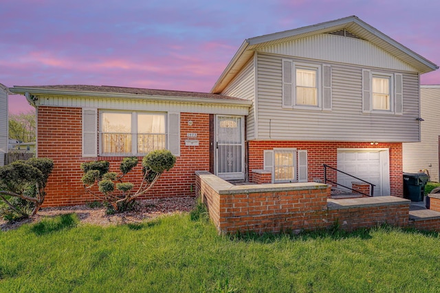 1473 Venice Dr, Columbus, OH 43207 - tri-level home featuring brick siding, a yard, and a garage