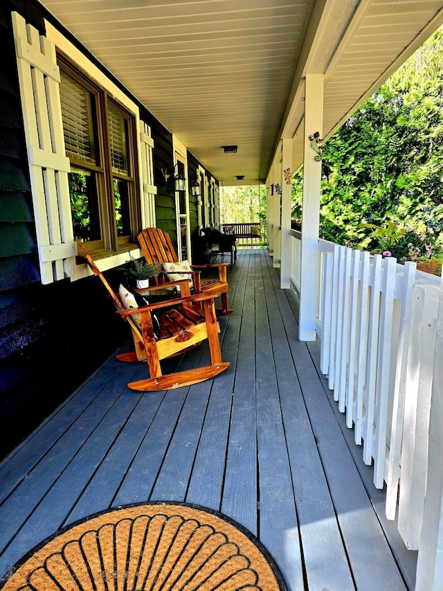 wooden terrace with a porch
