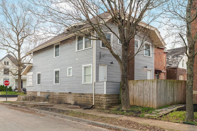 view of side of property featuring fence