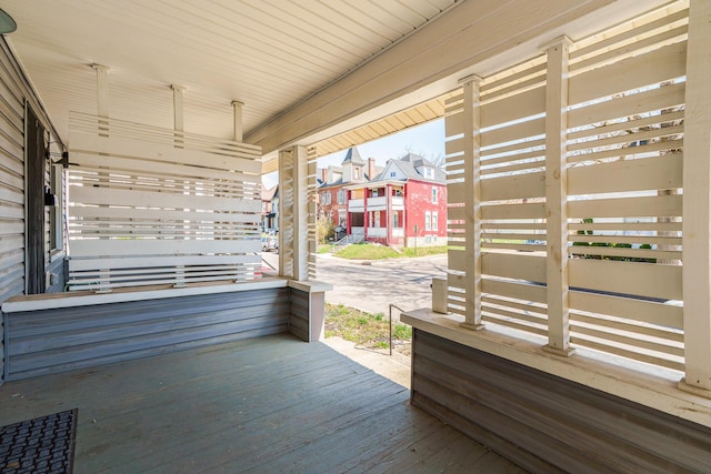 deck with a porch and a residential view