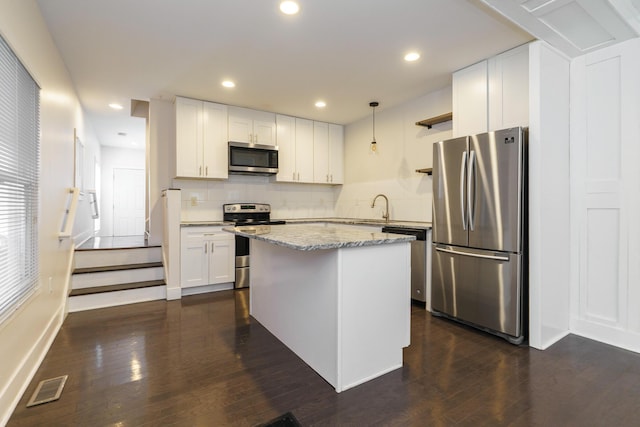 kitchen with white cabinets, visible vents, appliances with stainless steel finishes, and dark wood finished floors