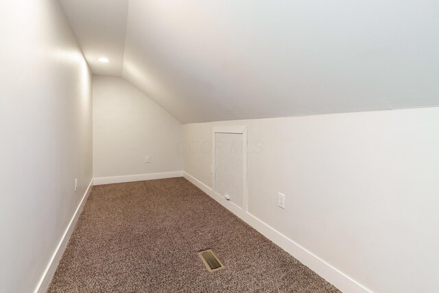 additional living space featuring carpet, baseboards, lofted ceiling, visible vents, and recessed lighting