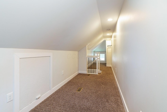 additional living space with recessed lighting, vaulted ceiling, visible vents, baseboards, and carpet flooring