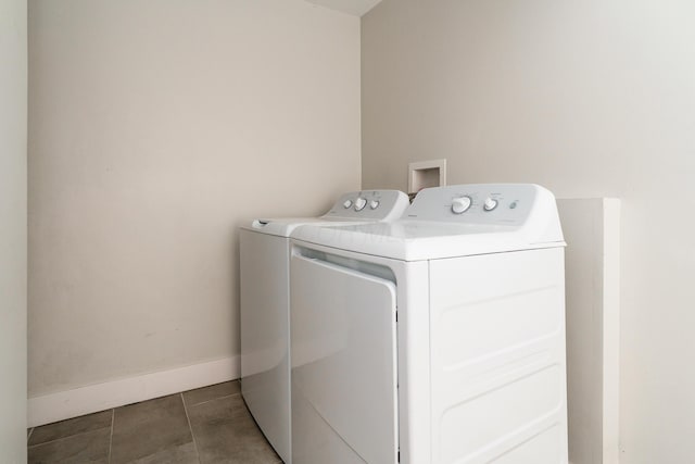 clothes washing area featuring baseboards, tile patterned floors, laundry area, and independent washer and dryer