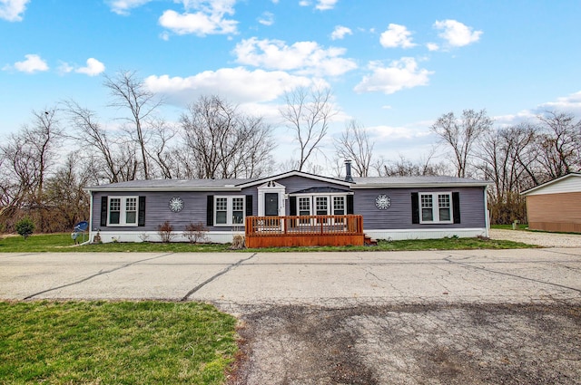 manufactured / mobile home featuring metal roof and a wooden deck