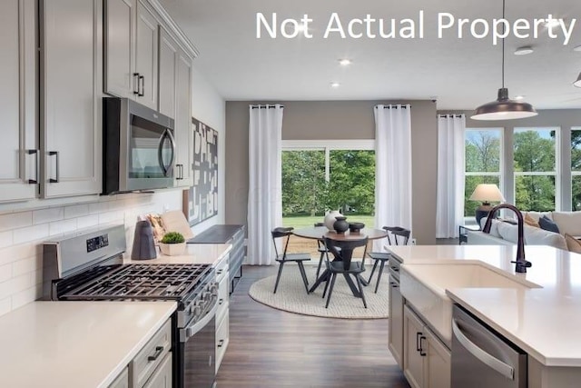 6326 Anguria Dr Lot 244, Hilliard, OH 43026 - kitchen featuring stainless steel appliances, light countertops, dark wood-style flooring, healthy amount of natural light, and recessed lighting