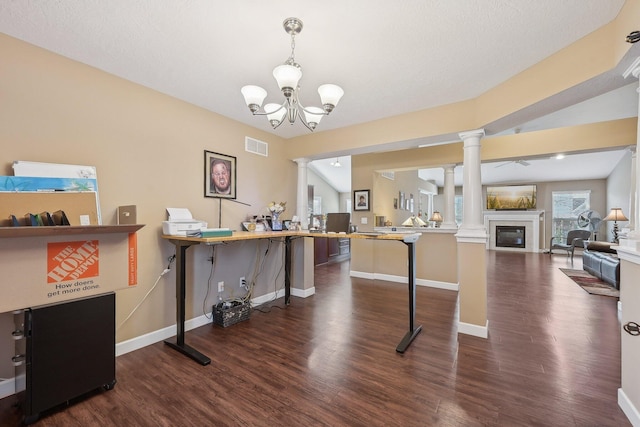 interior space featuring decorative columns, baseboards, dark wood finished floors, visible vents, and a glass covered fireplace