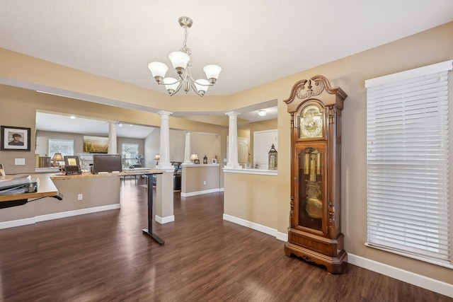 dining area with baseboards, a chandelier, decorative columns, and dark wood finished floors