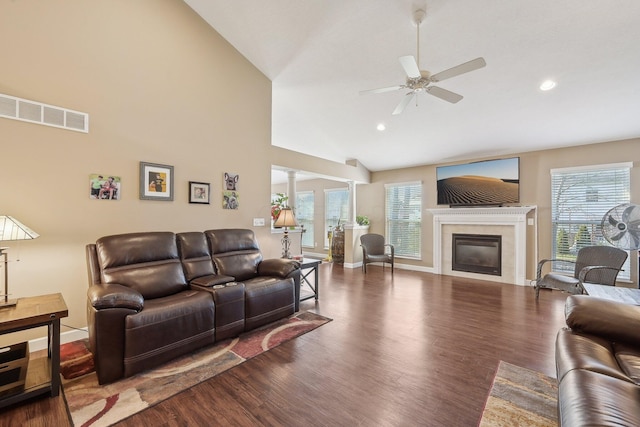 living room with wood finished floors, a wealth of natural light, ceiling fan, and visible vents