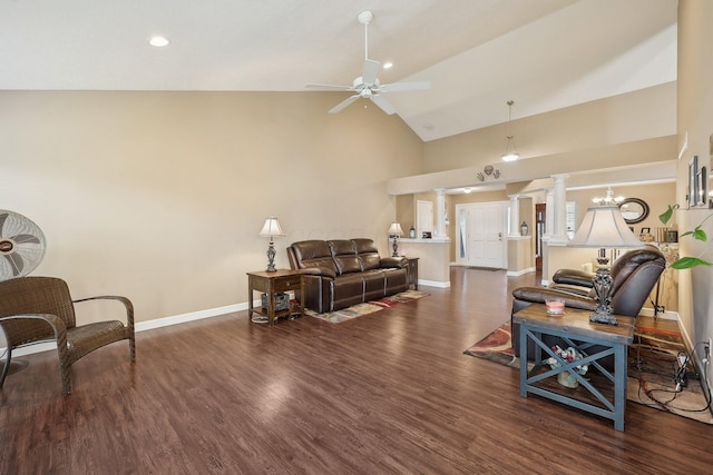 living area featuring decorative columns, high vaulted ceiling, wood finished floors, baseboards, and ceiling fan