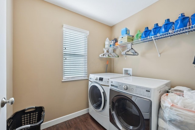 laundry area with washer and clothes dryer, dark wood-type flooring, baseboards, and laundry area