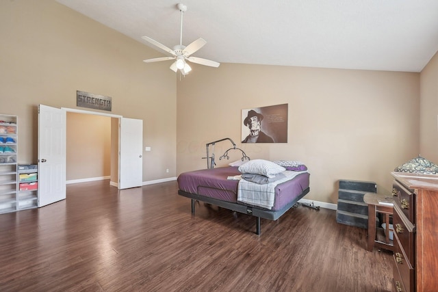 bedroom with baseboards, high vaulted ceiling, and wood finished floors