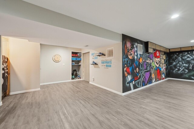 playroom with wood finished floors, baseboards, and visible vents