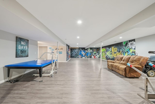 recreation room with baseboards, wood finished floors, and recessed lighting