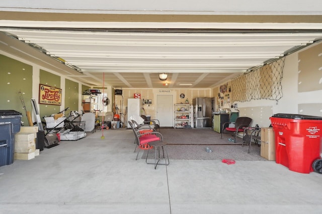 garage with stainless steel fridge