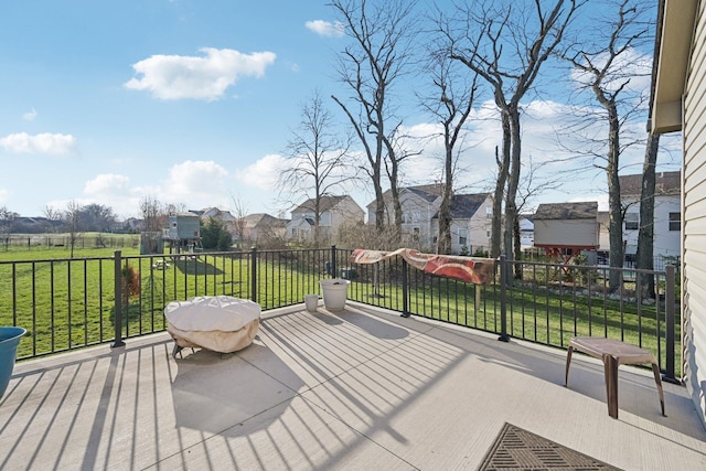 deck featuring a lawn and a residential view