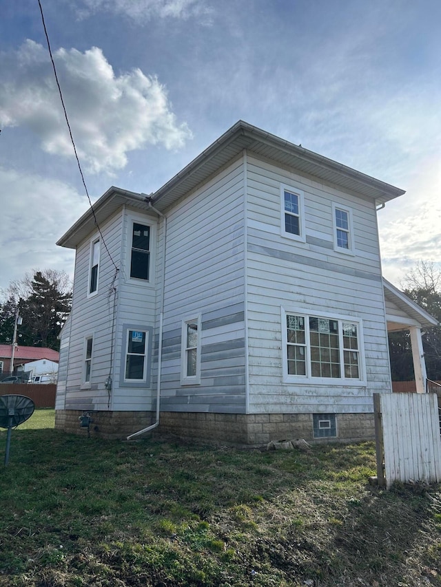 view of side of property with a lawn