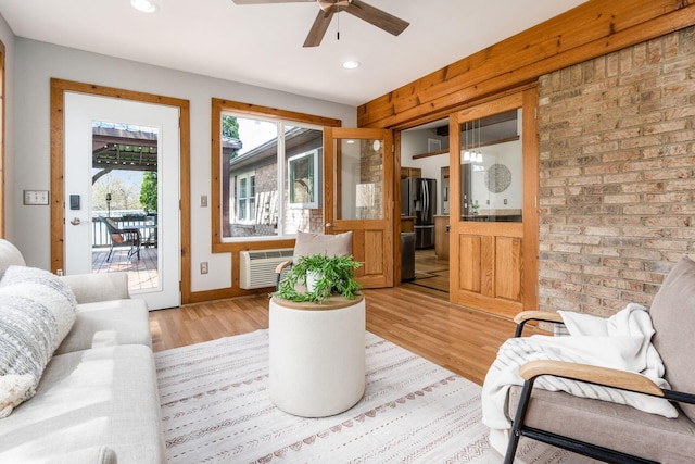 interior space with recessed lighting, an AC wall unit, light wood-style floors, baseboards, and ceiling fan