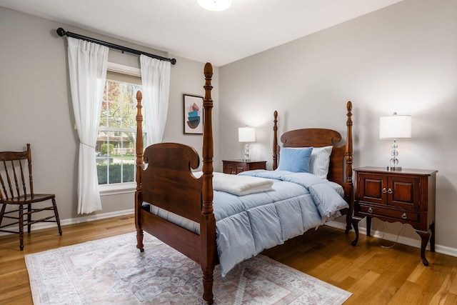 bedroom featuring light wood-style flooring and baseboards
