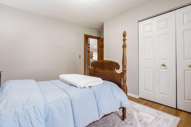 bedroom featuring wood finished floors and a closet