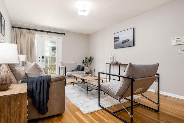 sitting room featuring light wood-style flooring and baseboards