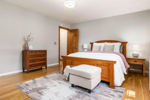bedroom with light wood-style flooring and baseboards
