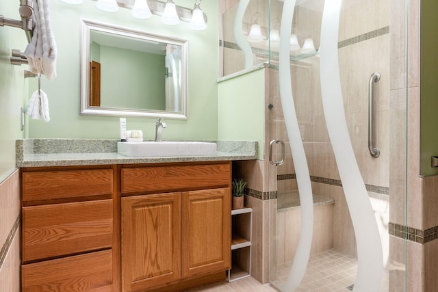bathroom with a shower stall and vanity