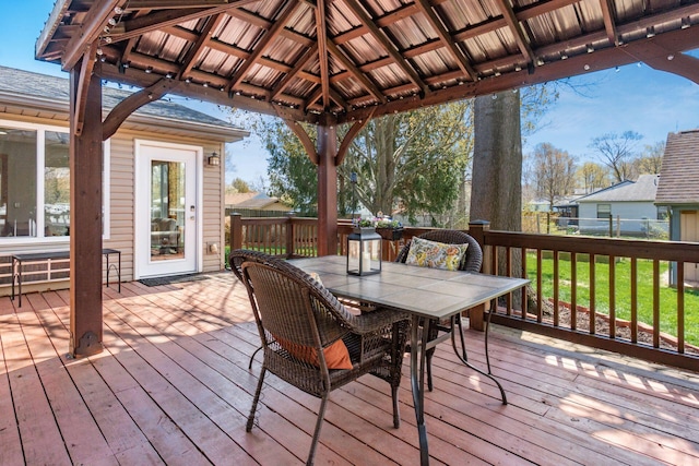 deck featuring a gazebo, a lawn, and outdoor dining area