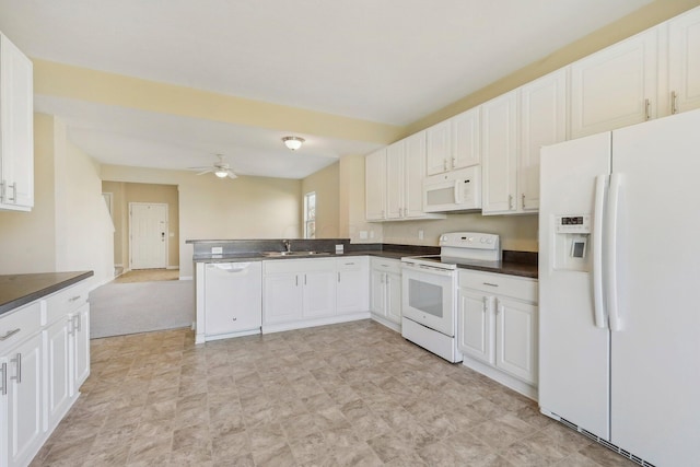 kitchen featuring white cabinets, dark countertops, a ceiling fan, and white appliances