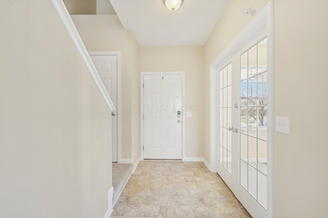 foyer featuring baseboards