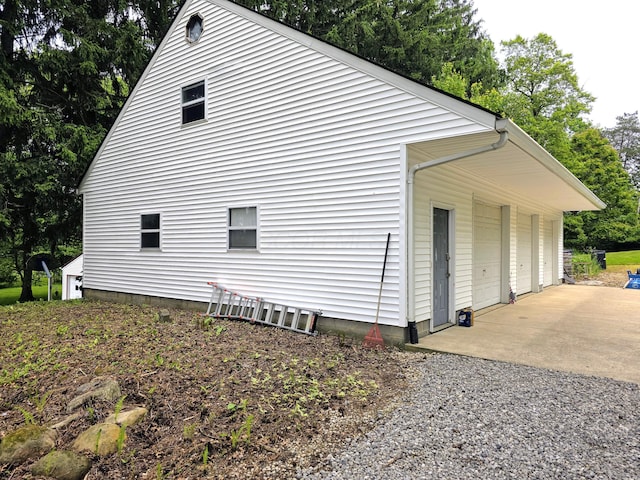 5344 Ridge Ave SE, Canton, OH 44707 - view of property exterior with a garage and view of scattered trees