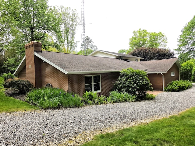 5344 Ridge Ave SE, Canton, OH 44707 - view of home's exterior with a shingled roof, a chimney, and brick siding